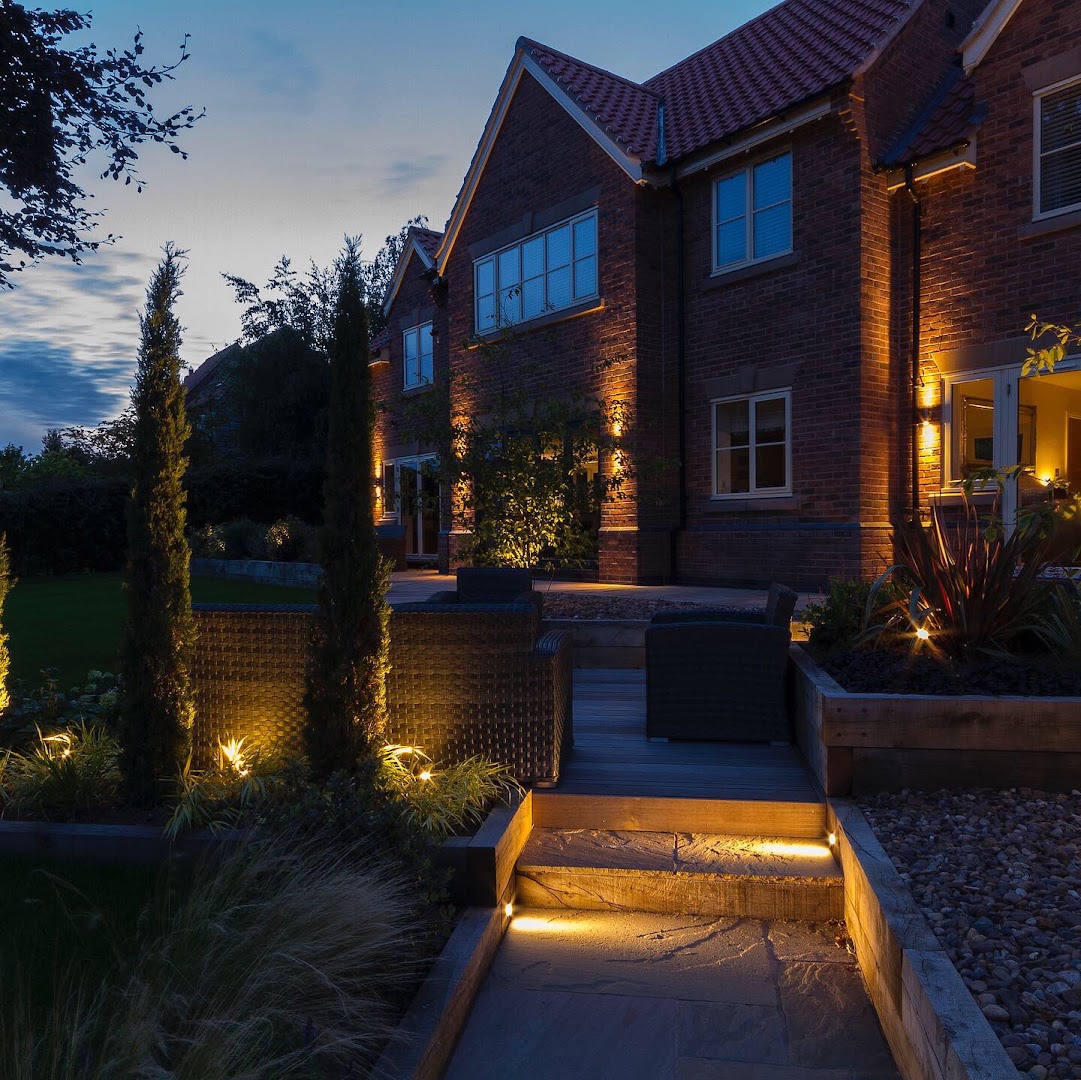 Stone dining terrace with steps into garden