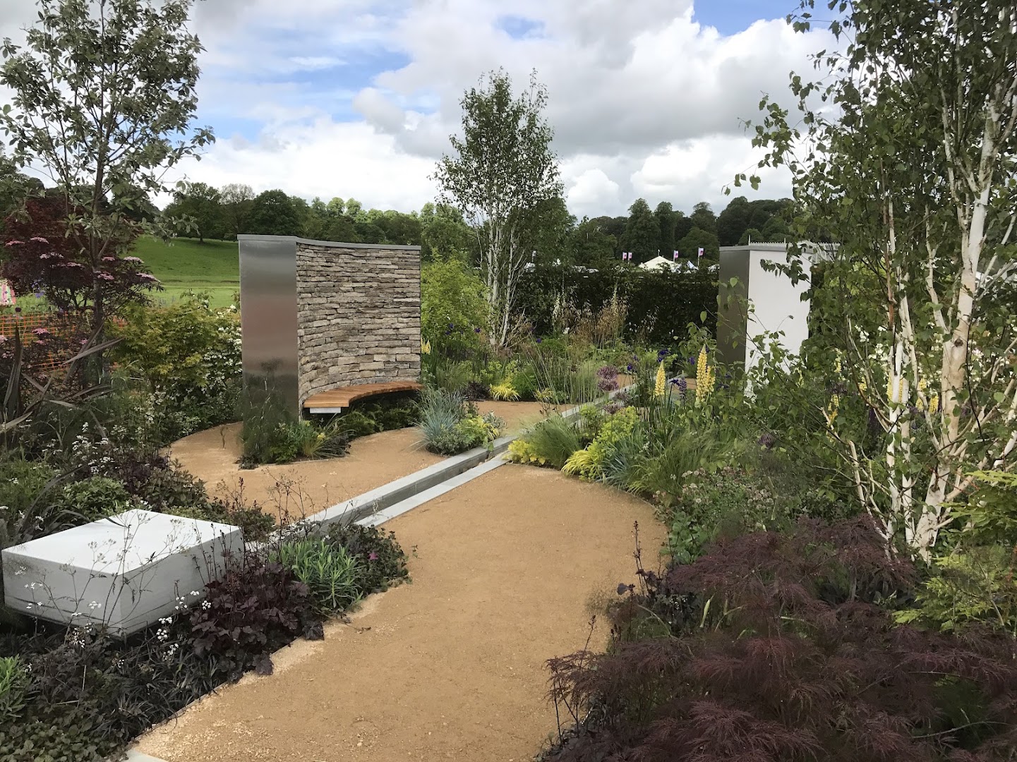 Sculptural corten and stone garden room by Creative Roots
